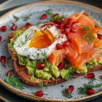 Smashed Avocado and smoked salmon on toast with fresh pomegranate and poached egg